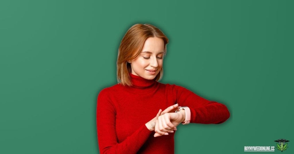 woman wearing red looking at her watch