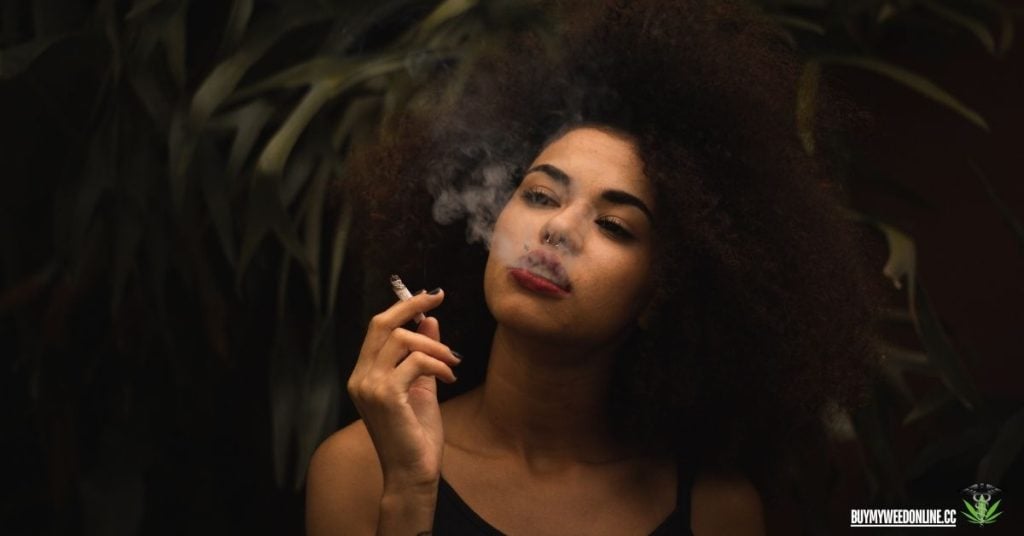 woman smoking on a black background