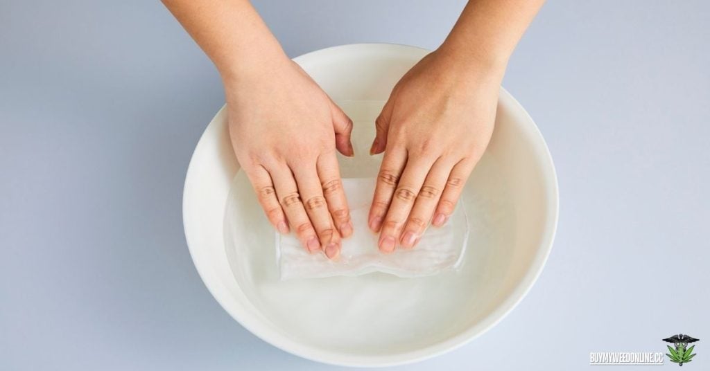 hands soaked in warm water