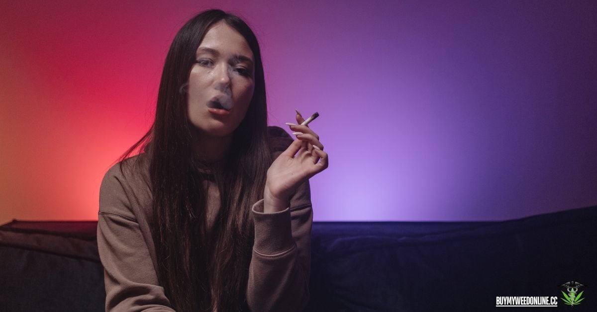 woman smoking weed with a red and purple background